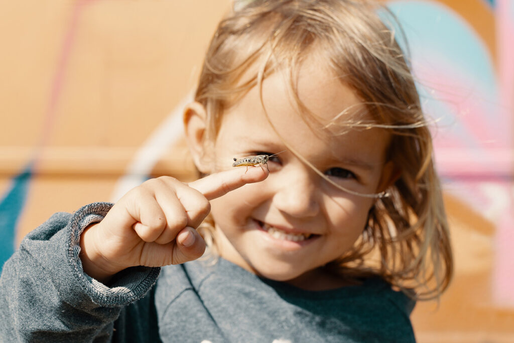Curious,Happy,Child,Holding,A,Grasshopper.,Little,Girl,Exploring,The