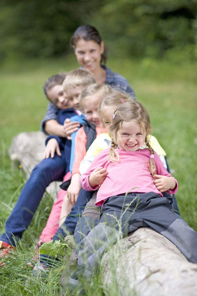 Kindergarten,Teacher,Playing,With,Kids,On,A,Log,Wood,Kindergarten