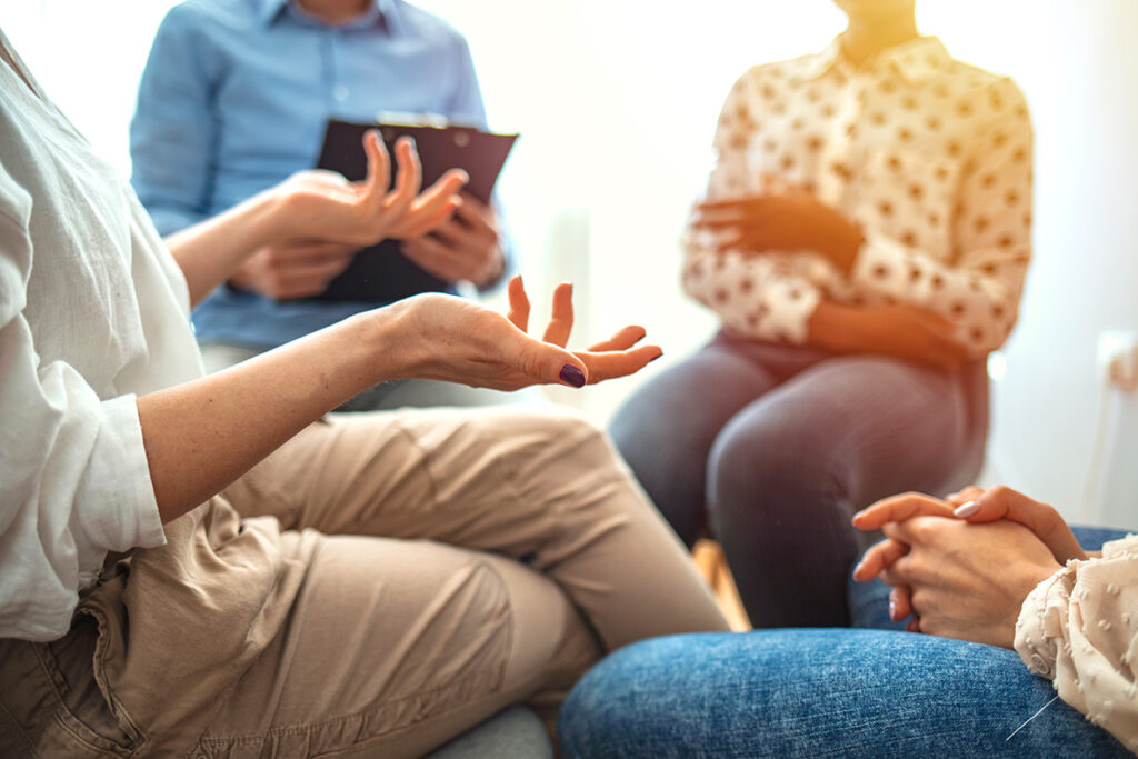 Woman,Gestures,While,Discussing,Something,Difficult,During,A,Support,Group